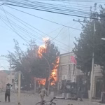 A fiery explosion is seen at the end of a suburban street
